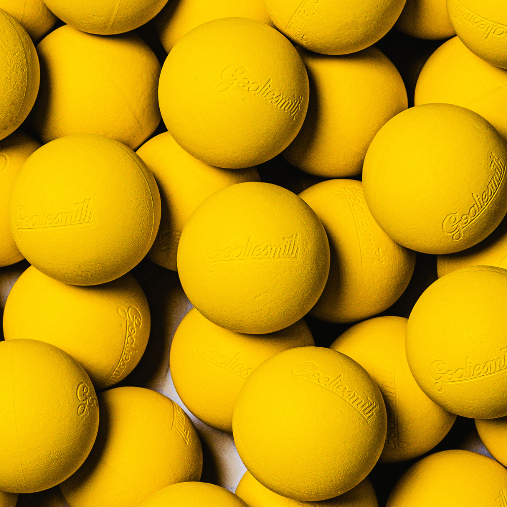 Pile of bright yellow Goaliesmith soft lacrosse practice balls